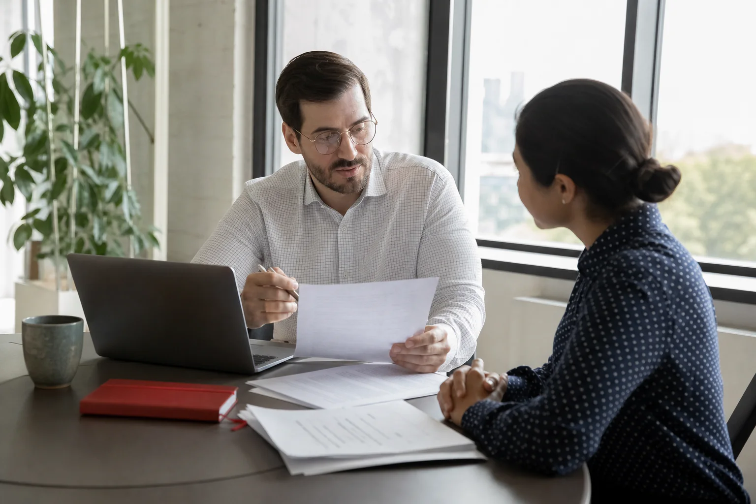 Hiring professional comparing a candidate résumé with employment history records